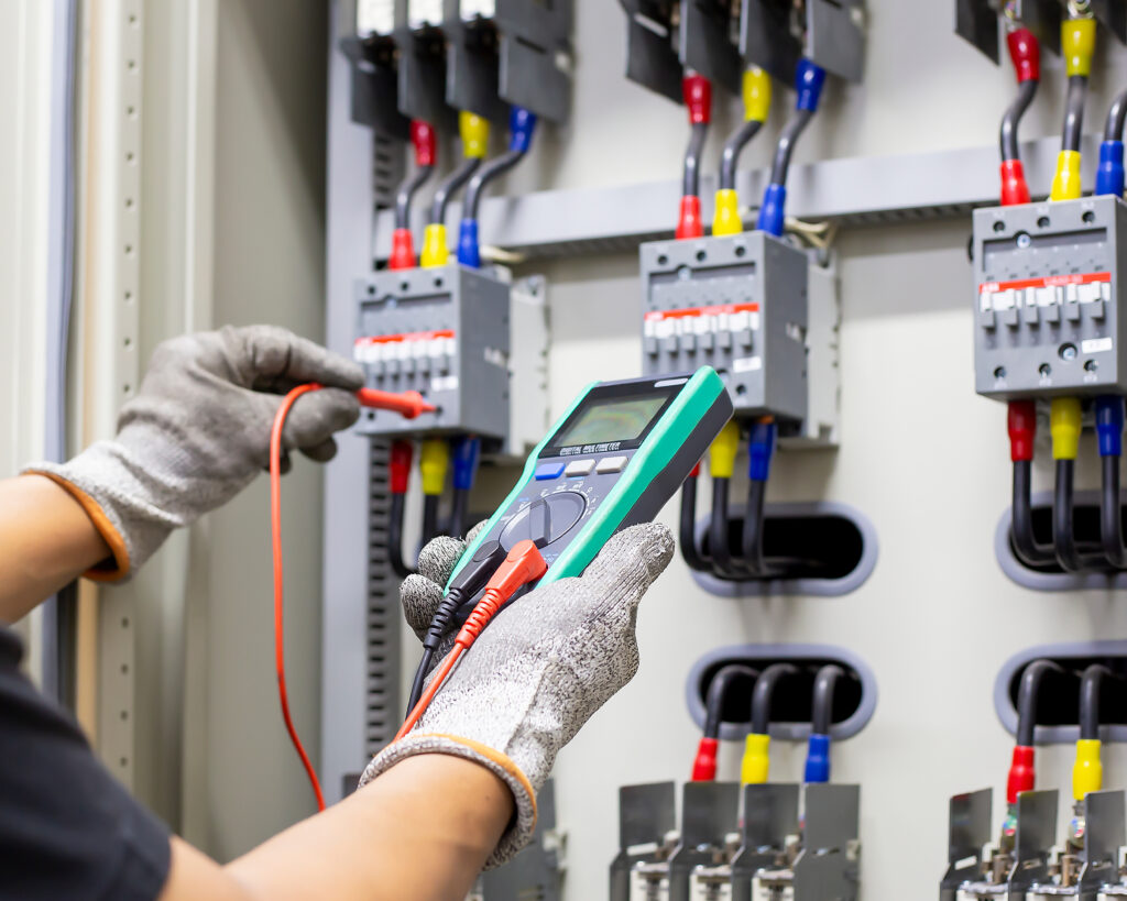 Electrical engineers check electrical control equipment.